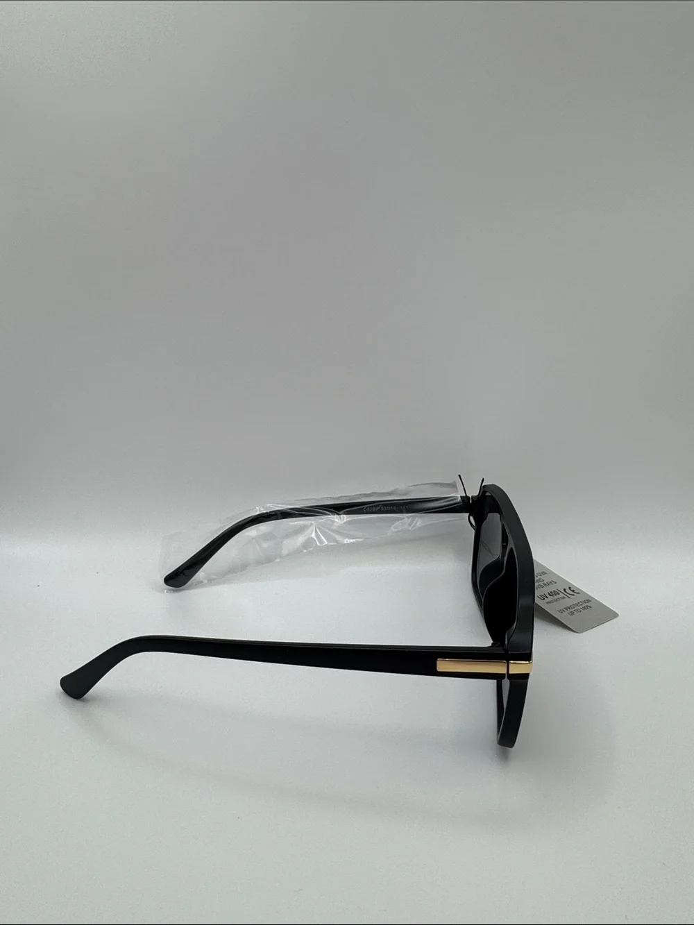 Black Sunglasses with Dark Lenses and Gold Accents